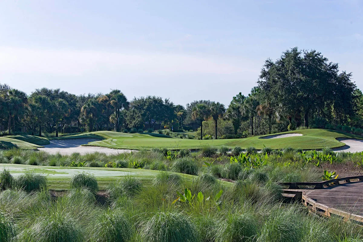 Golf course framed by native grasses at Kensington Golf and Country Club, Naples.