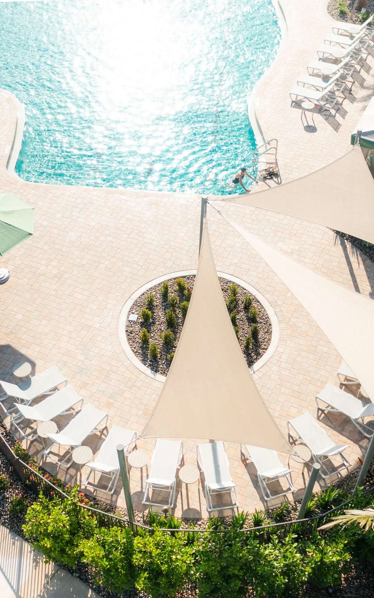 Aerial pool and sun-sail lounges at Kensington (official club site).