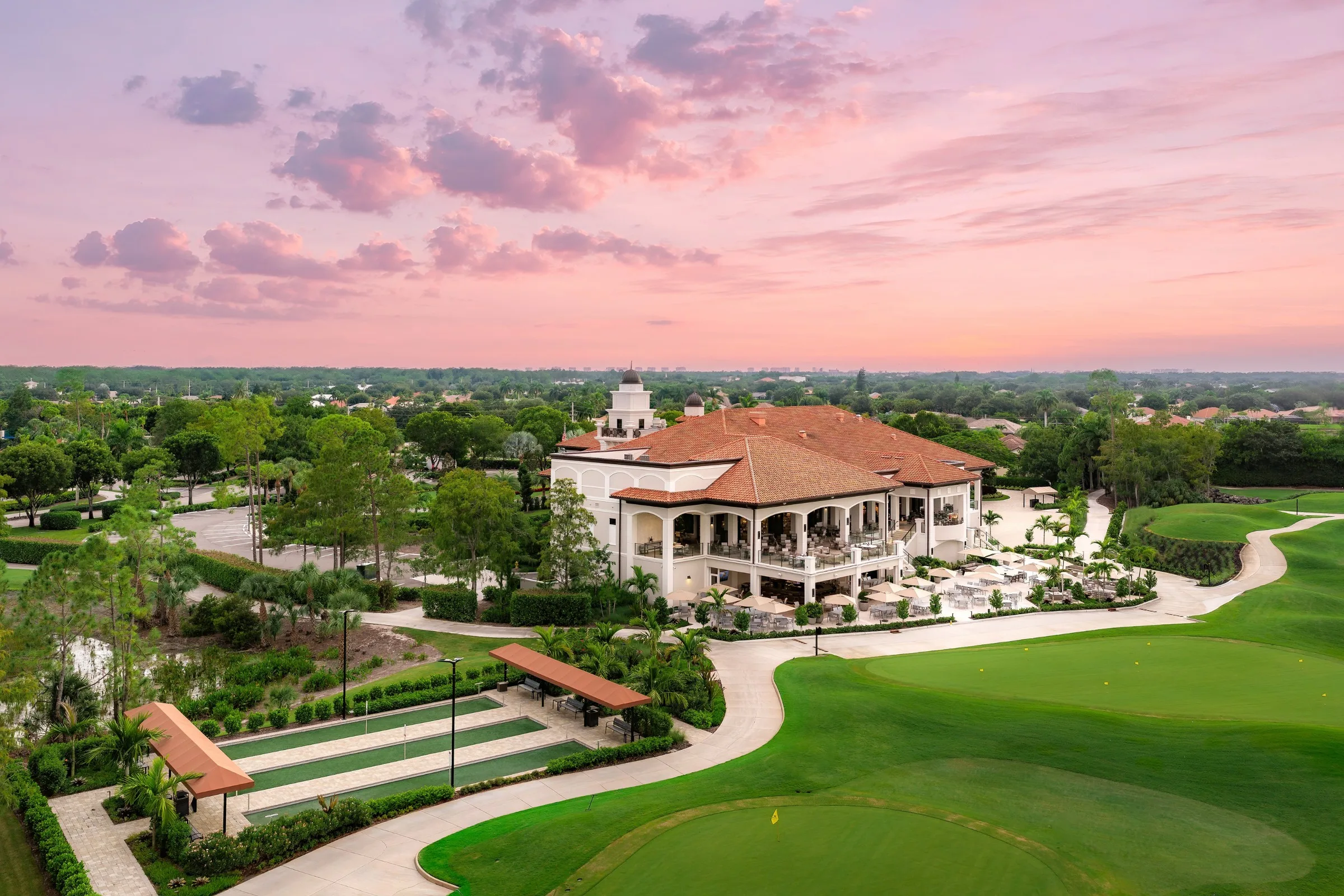 Aerial clubhouse and bocce courts at sunset, Olde Cypress (official club site).