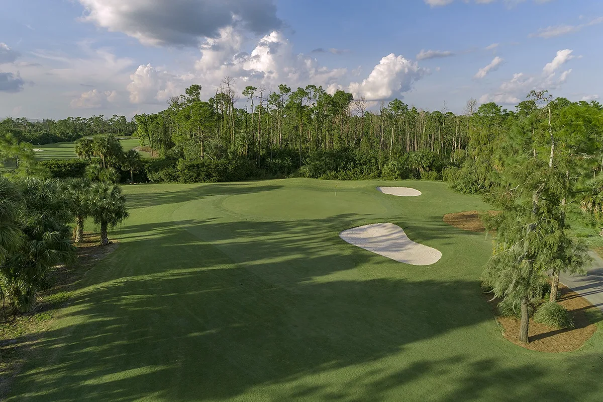 Aerial of a tree-lined golf hole at Valencia Golf and Country Club, Naples (official club site).