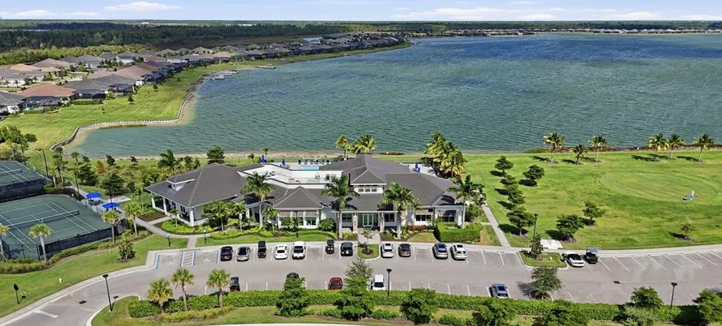 Aerial of the WildBlue clubhouse, courts and lake