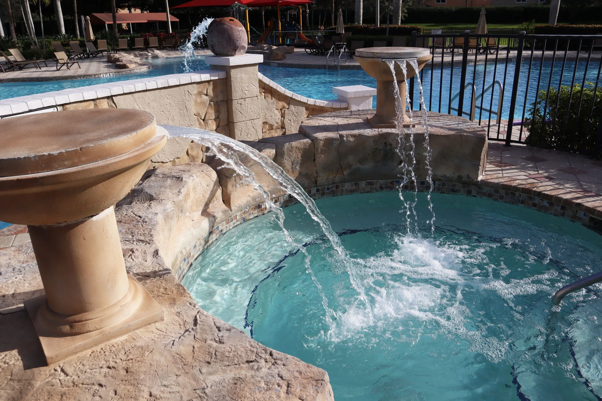 Fountain-fed hot tub at the Bella Terra pool, Estero (official community site).