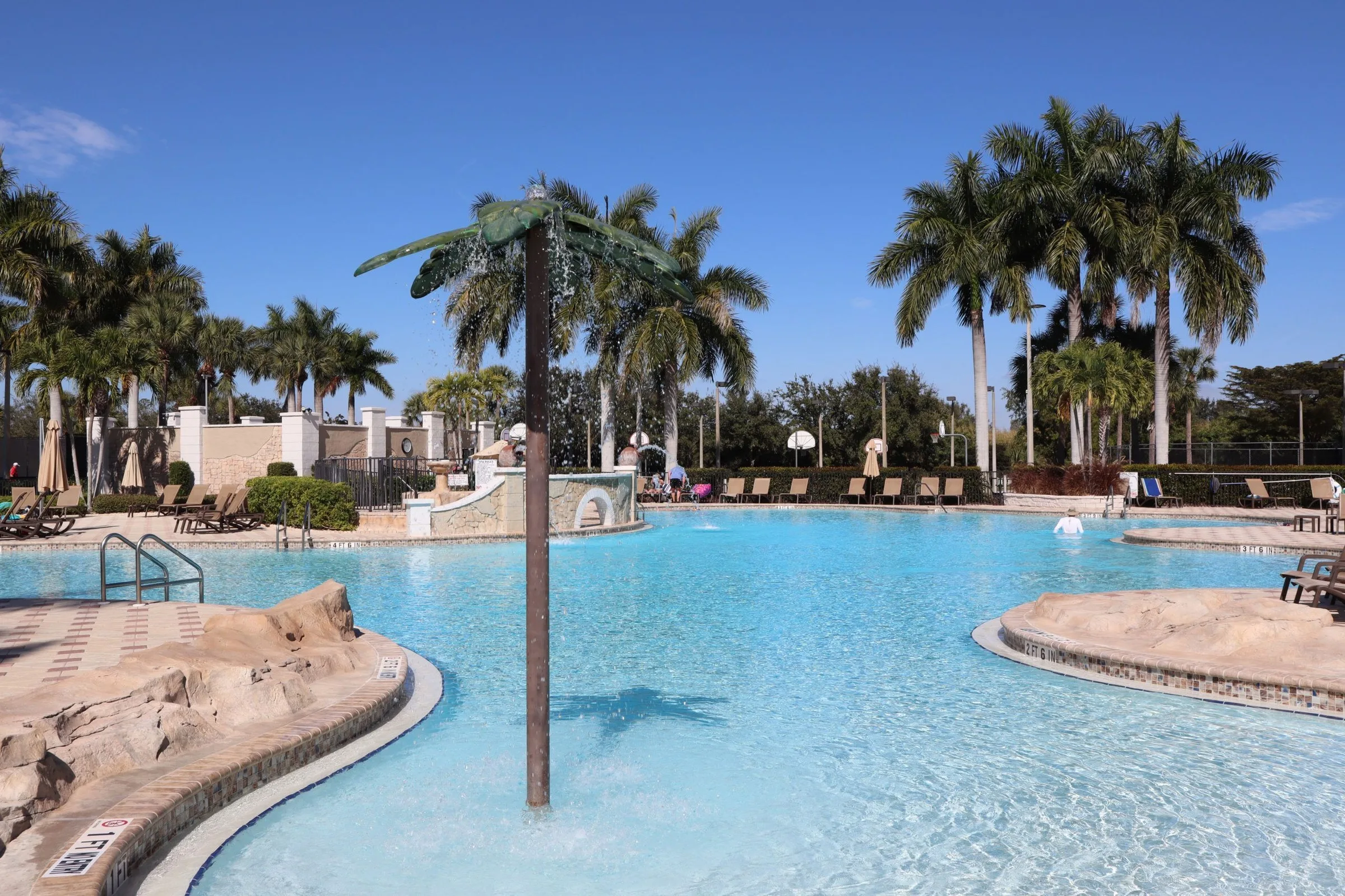 Resort pool with a palm island at Bella Terra.