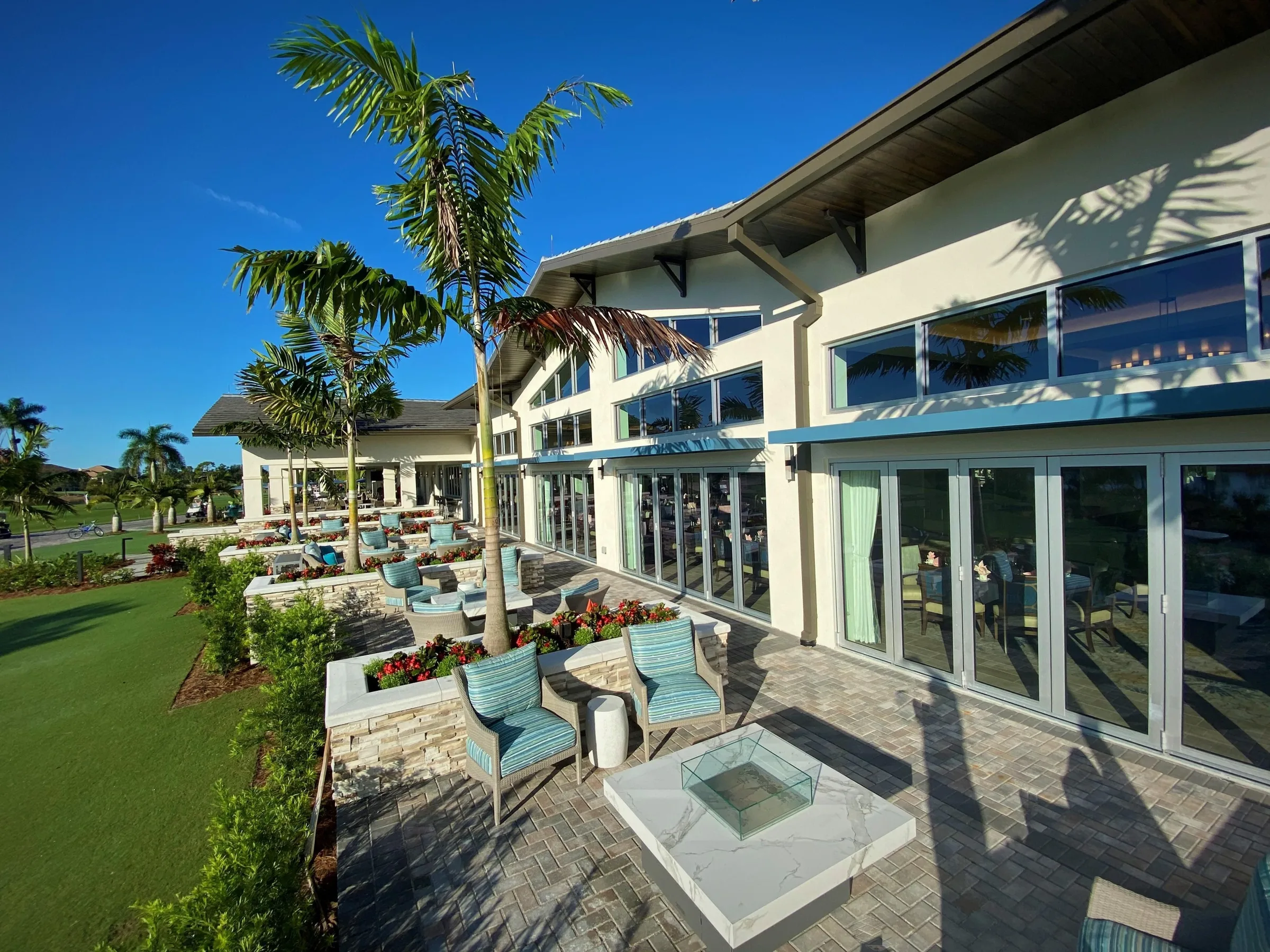 Clubhouse terrace with fire pit at Pelican Sound, Estero (official club site).