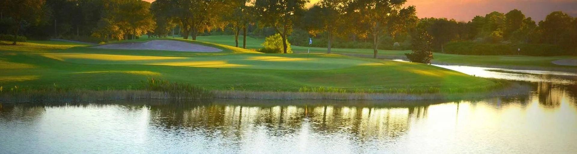 Golf course lake at sunset, Pelican Sound, Estero (official club site).