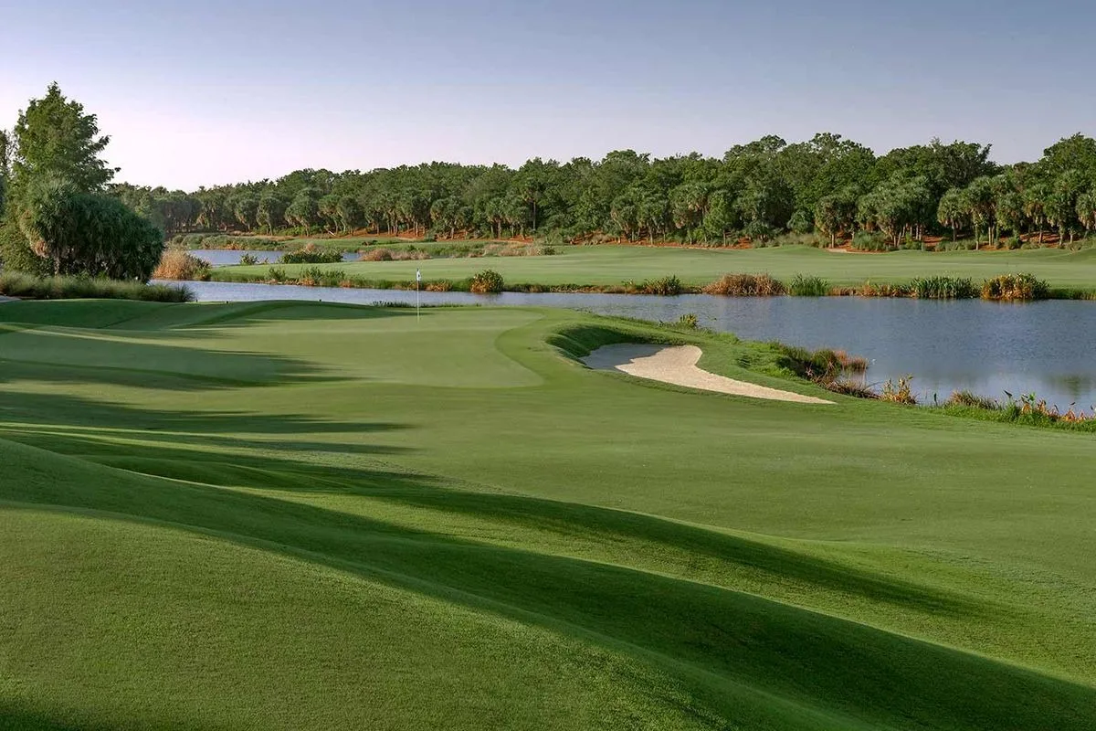 Golf hole beside a lake at Miromar Lakes Golf Club.
