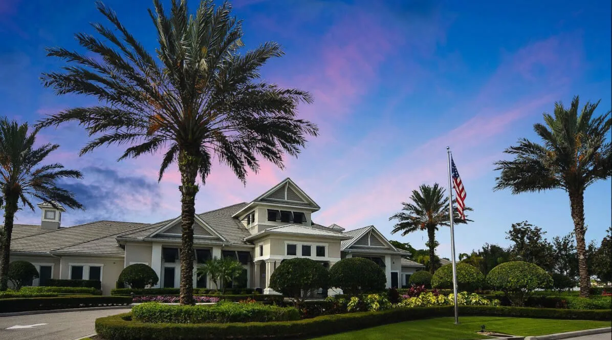 Corkscrew Shores clubhouse and flag at dusk
