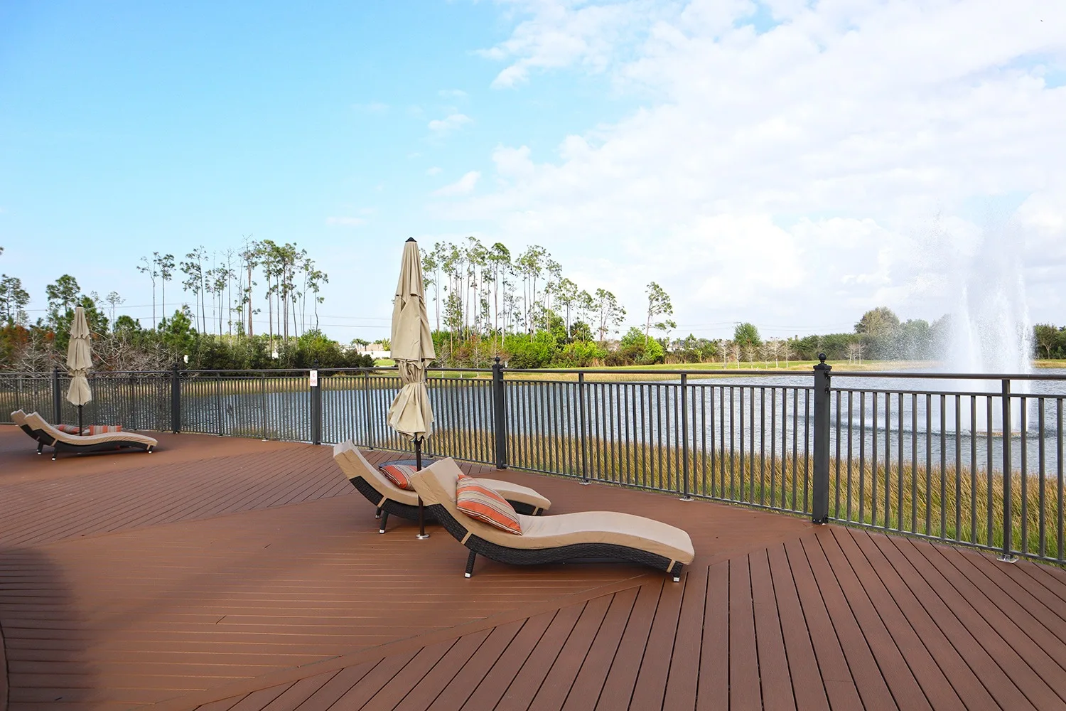 Lakeside deck with loungers at The Preserve at Corkscrew, Estero (official HOA site).