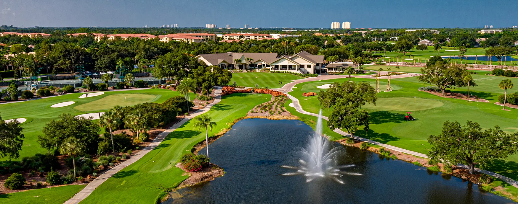 Golf course, lake fountain, and clubhouse view at Estero Country Club / The Vines (official association).
