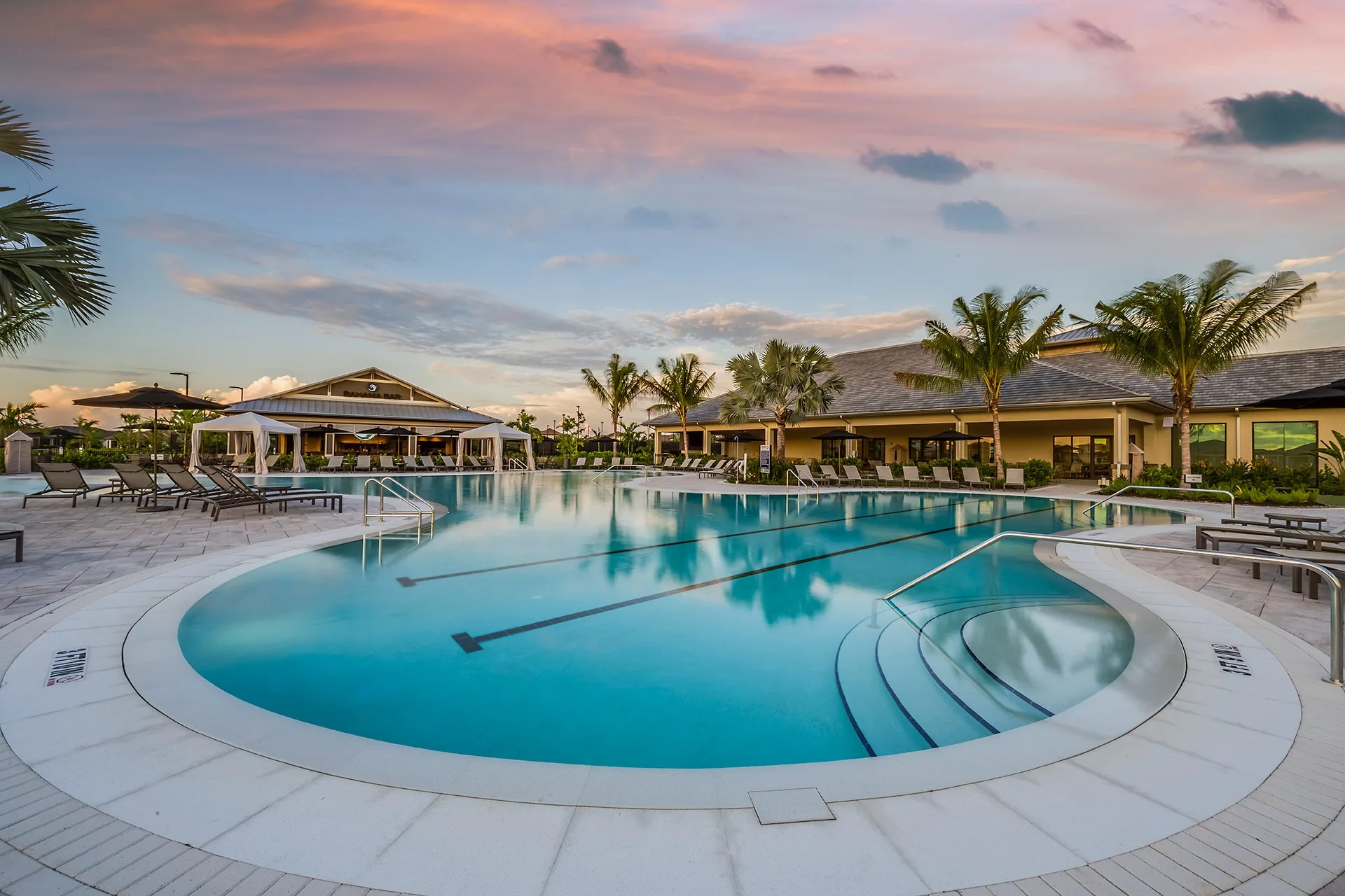 Resort pool and cabanas at sunset, Esplanade by the Islands, Naples (official lifestyle site).