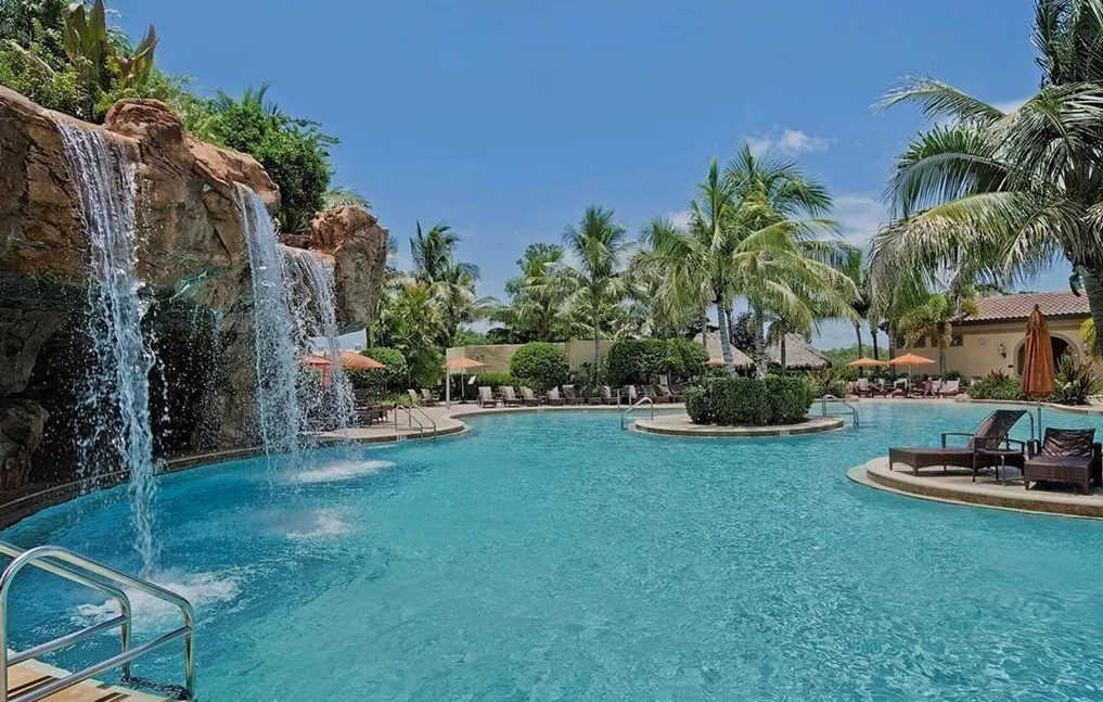 The Players Club & Spa resort pool with rock waterfall, part of Lely Resort's optional club membership