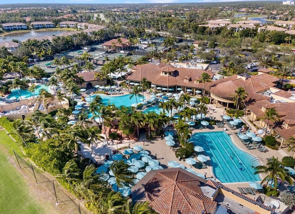 The Players Club & Spa resort pools and clubhouse from above, part of Lely Resort's optional club membership