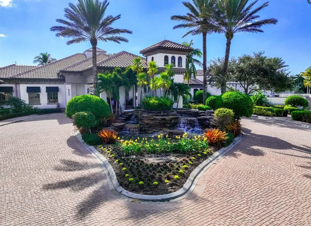 Clubhouse entry with fountain and palms at Lely Resort