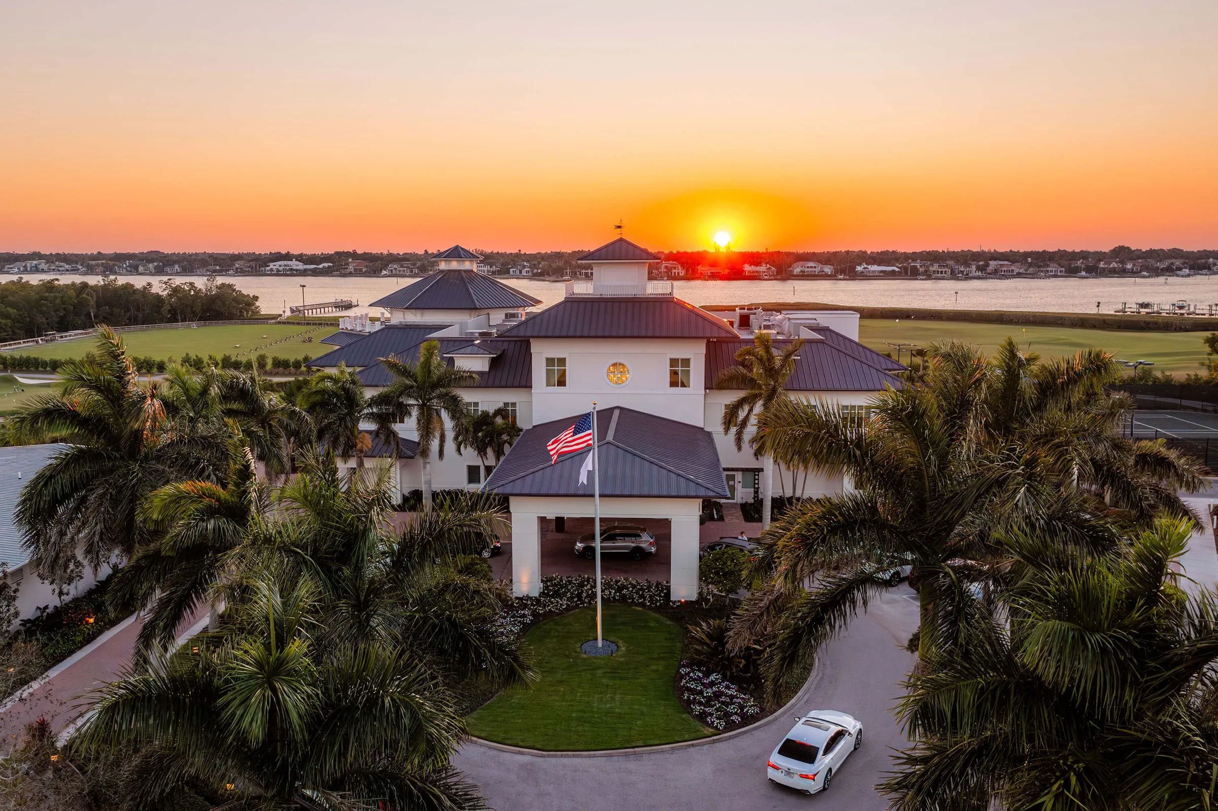 Clubhouse at sunset, Windstar on Naples Bay (official club site).