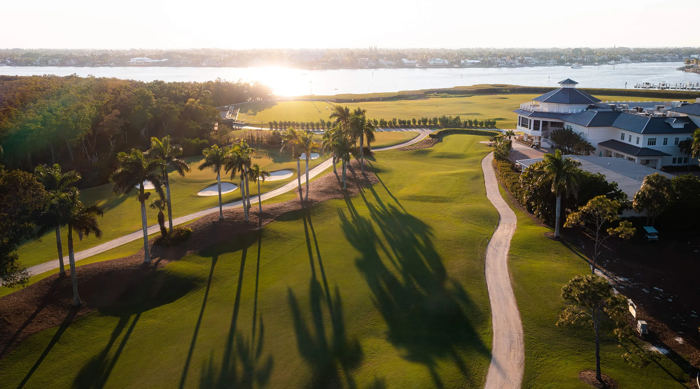 Aerial golf course at sunset, Windstar on Naples Bay (official club site).