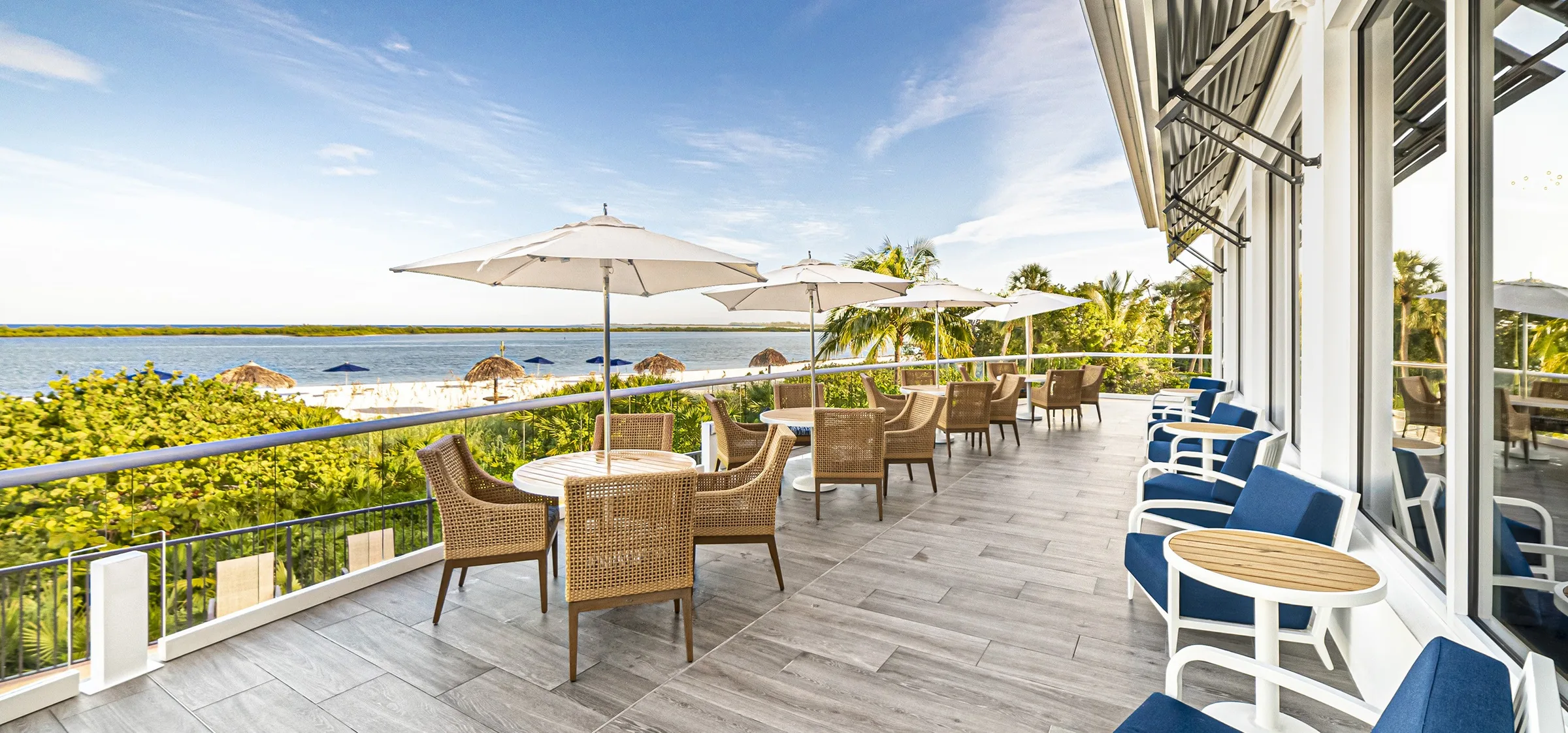 Waterfront clubhouse patio dining overlooking the beach at Hideaway Beach Club (official).