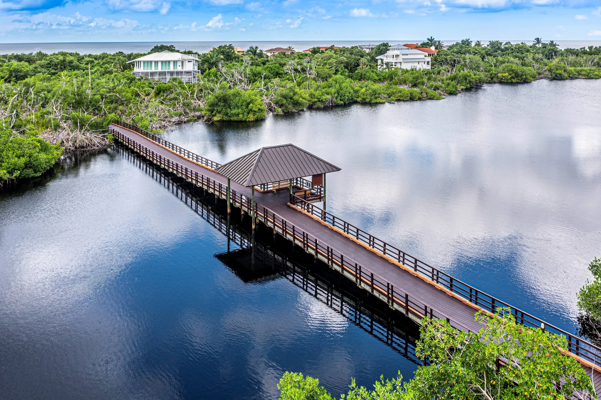 Aerial mangrove boardwalk and waterway at Hideaway Beach Club (official).