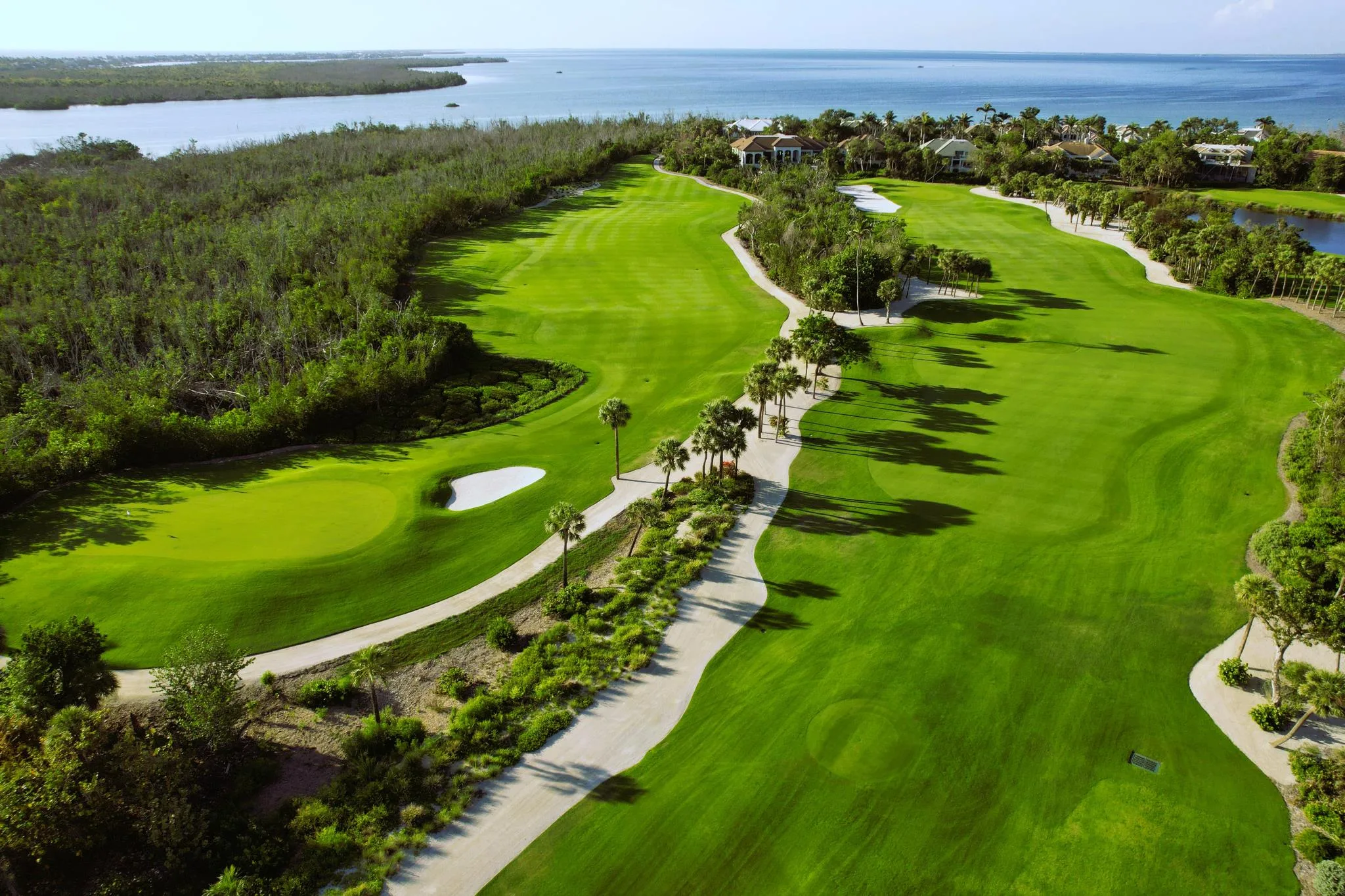 Aerial fairway with golf carts at The Sanctuary Golf Club (official).
