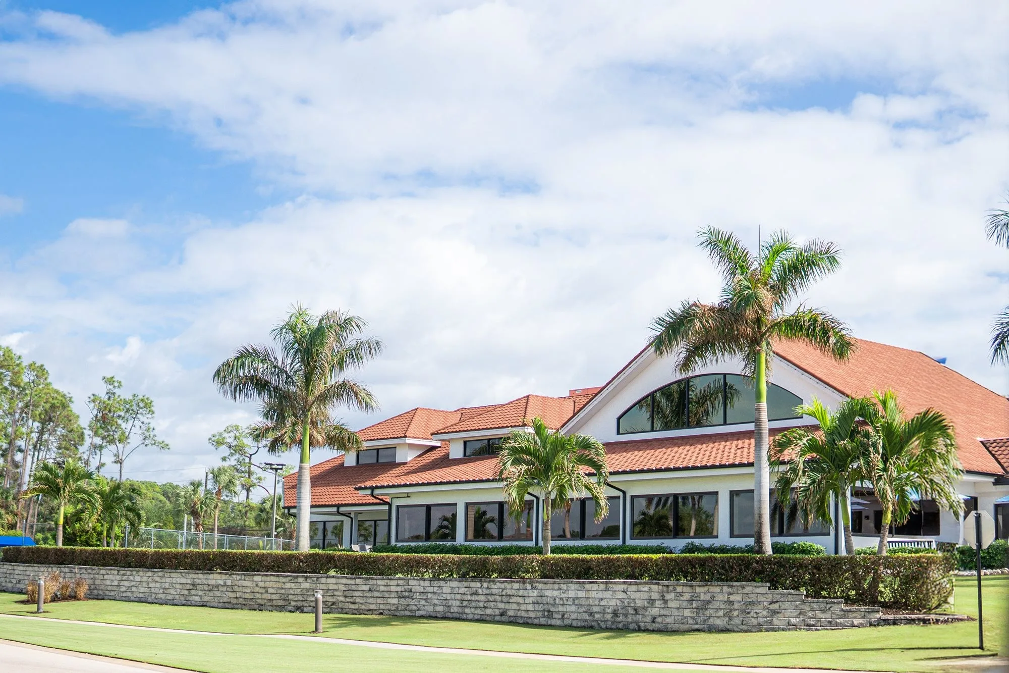 Clubhouse exterior at Royal Wood Golf and Country Club, Naples (official club site).
