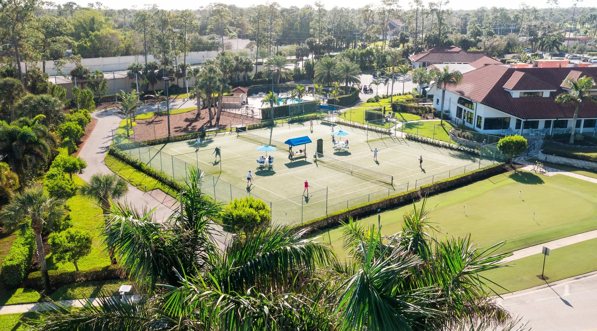 Aerial tennis courts pool and clubhouse amenities at Royal Wood (official club site).