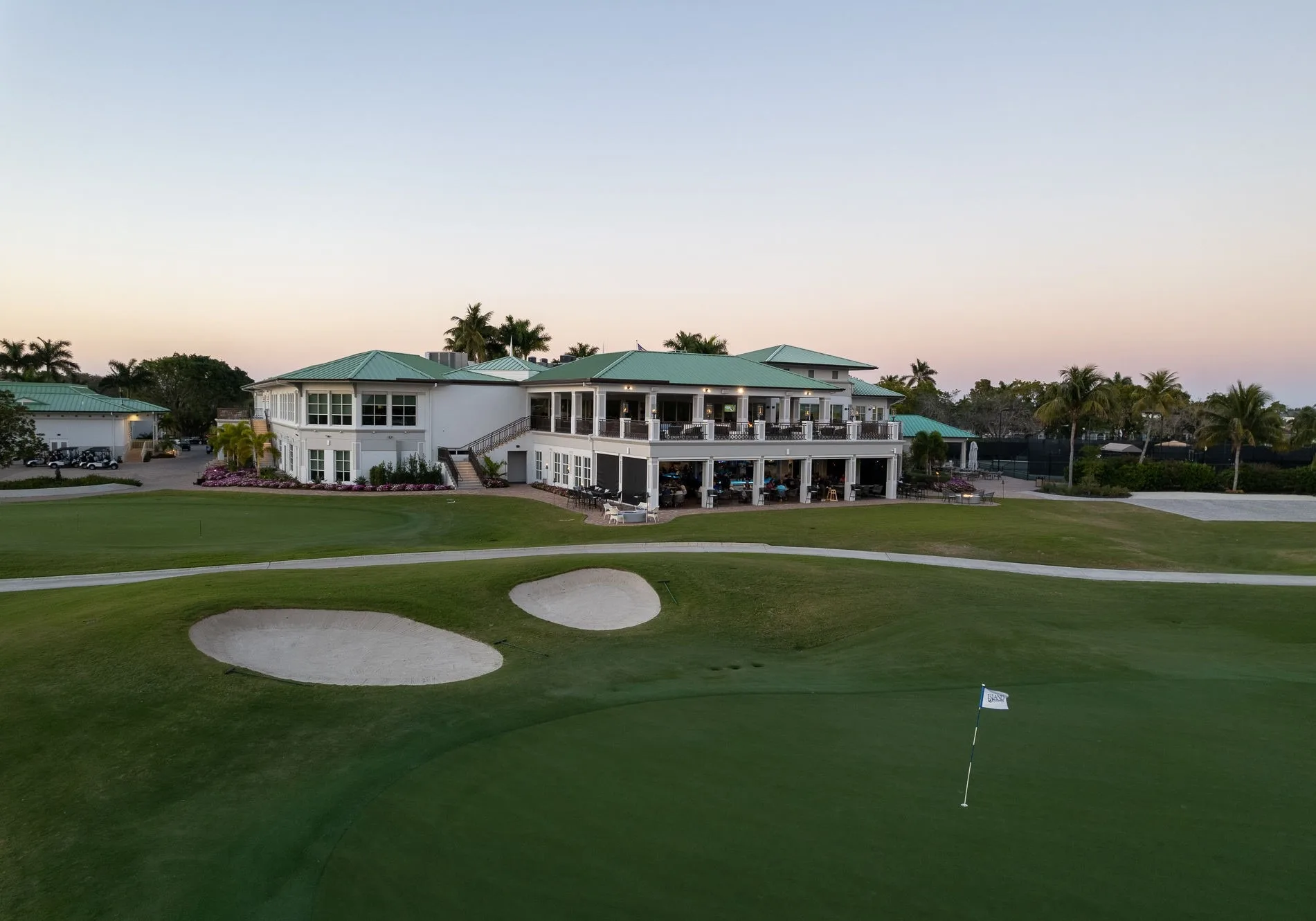 Clubhouse exterior at dusk overlooking the course at Island Country Club (official).