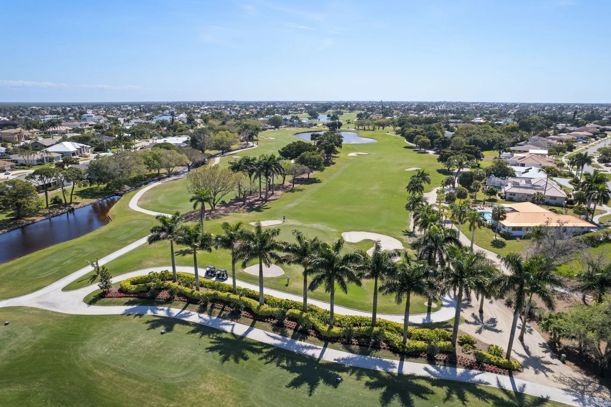 Aerial fairway view with homes at Island Country Club, Marco Island (official).