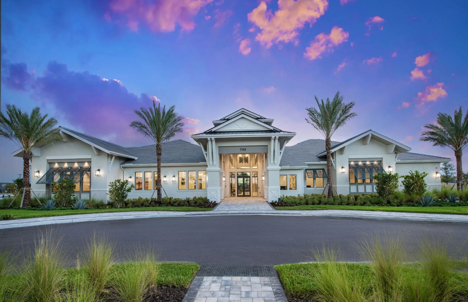 Clubhouse amenity center at dusk, Del Webb Oak Creek, North Fort Myers (official Del Webb site).
