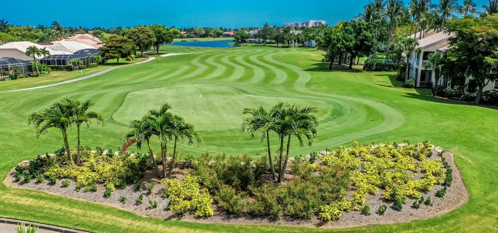 Golf hole with palm island landscaping at Gulf Harbour, Fort Myers (official club site).