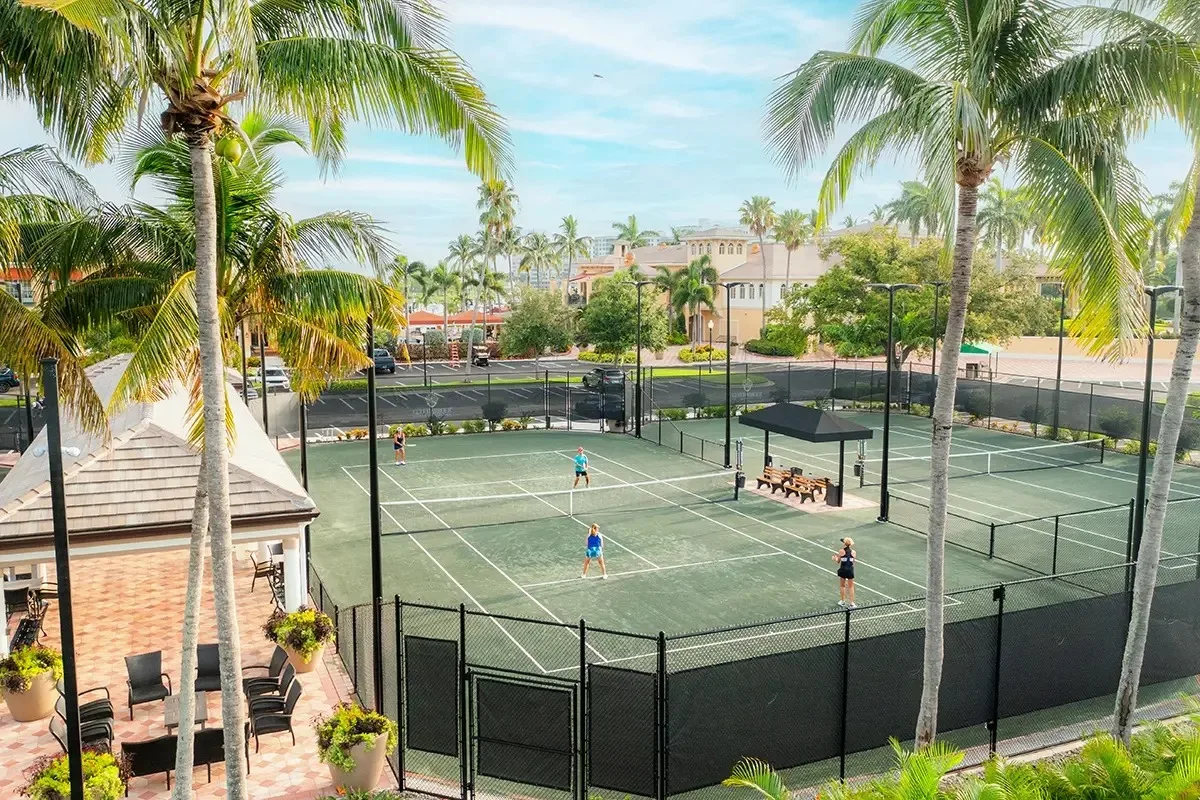 Tennis courts framed by palms at Gulf Harbour, Fort Myers (official club site).