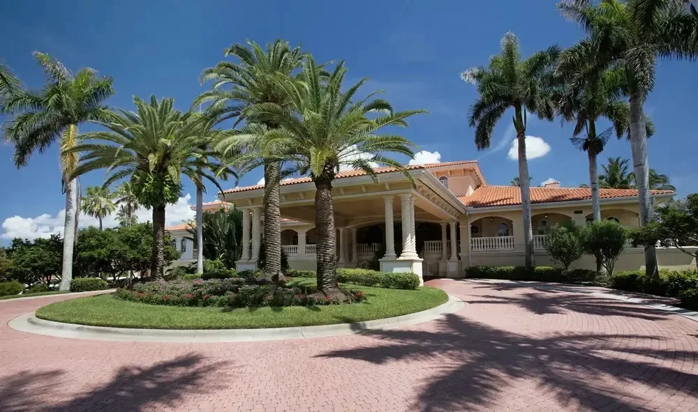 Palm-lined entrance drive at Gulf Harbour Yacht and Country Club, Fort Myers (official club site).