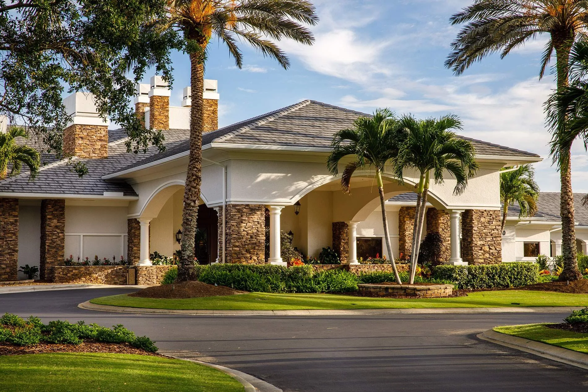 Clubhouse exterior and circular drive at Heritage Palms (official).