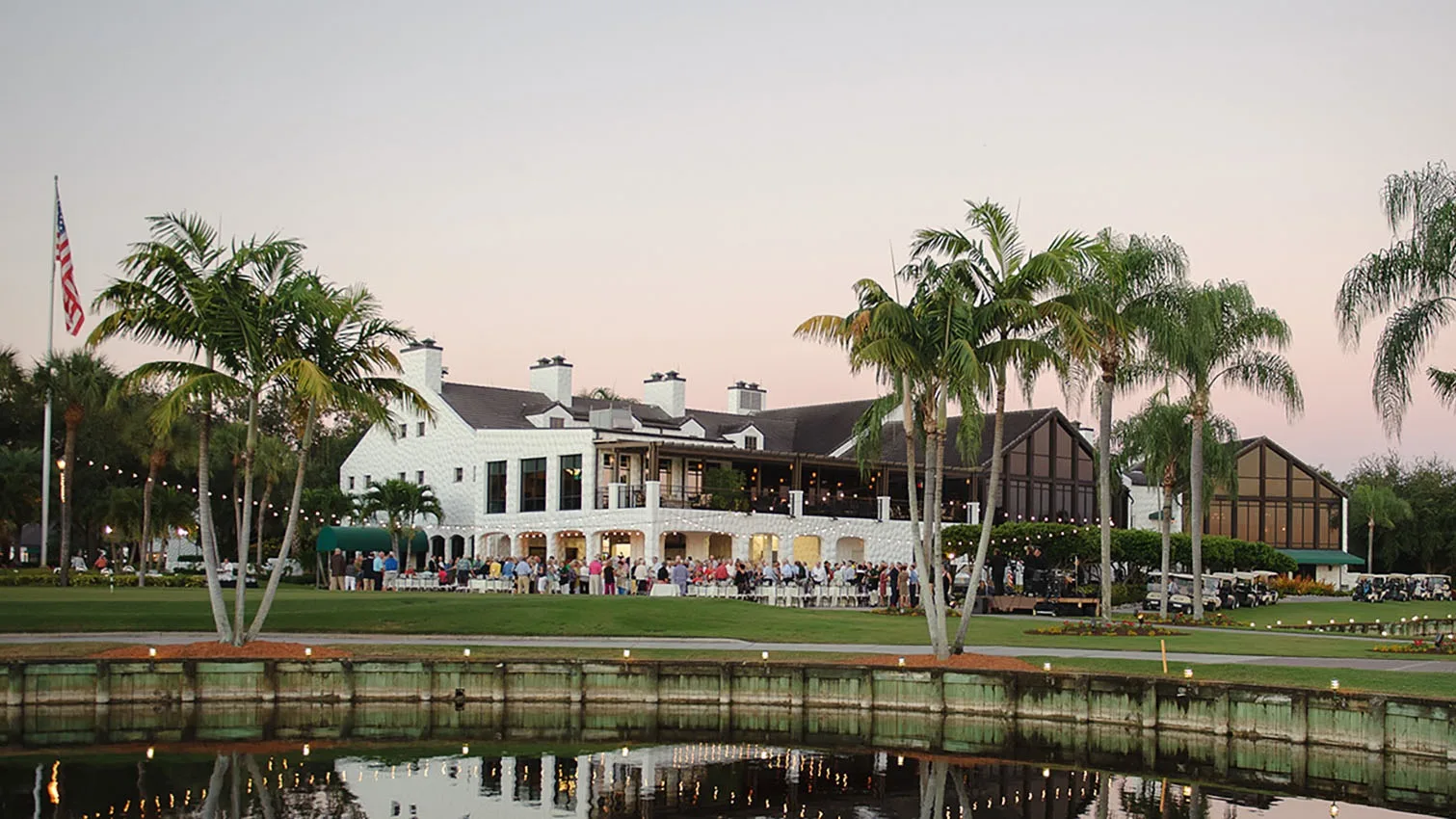 Clubhouse at dusk across the water at Fiddlesticks Country Club (official).