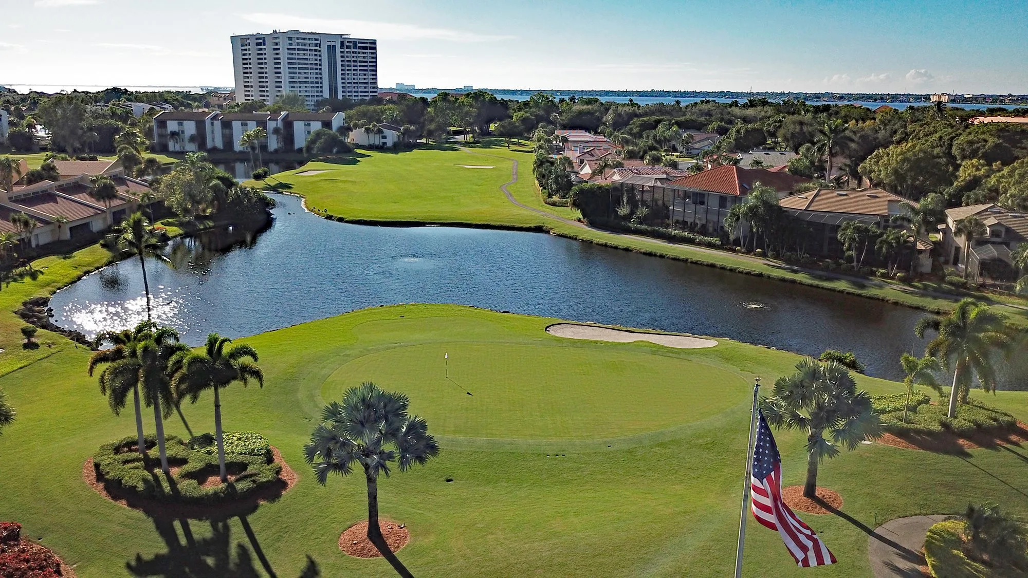 Golf green and lake aerial with residences at The Landings (official).