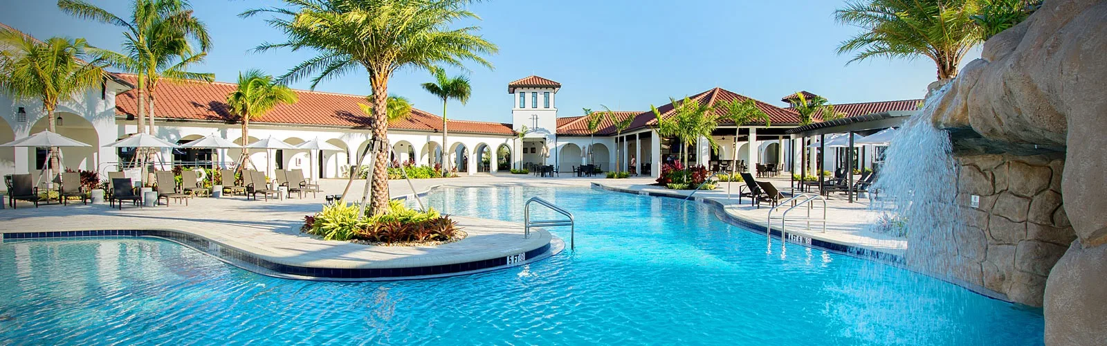 Resort pool with rock waterfall at the Arborwood Preserve Town Center, Fort Myers (official lifestyle site).