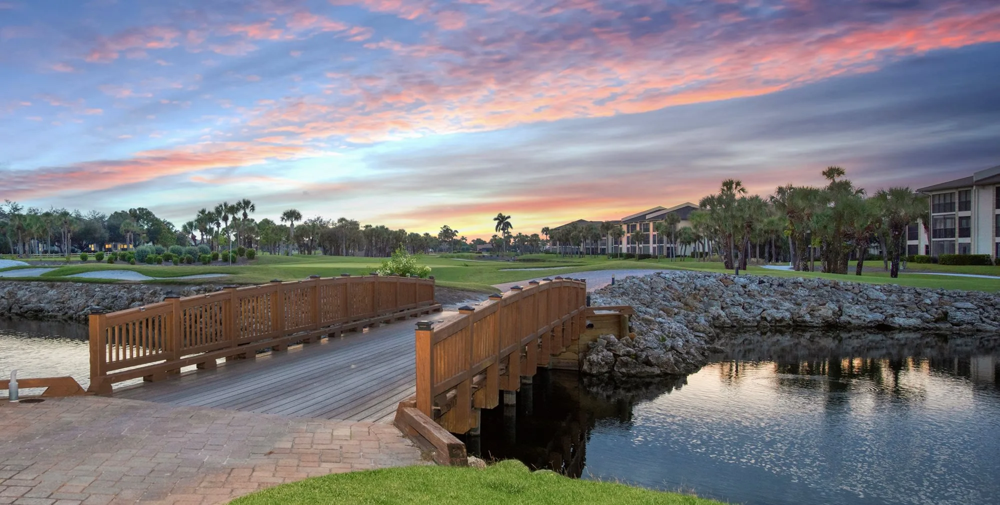 Sunset golf cart bridge at Kelly Greens Country Club (official club site).