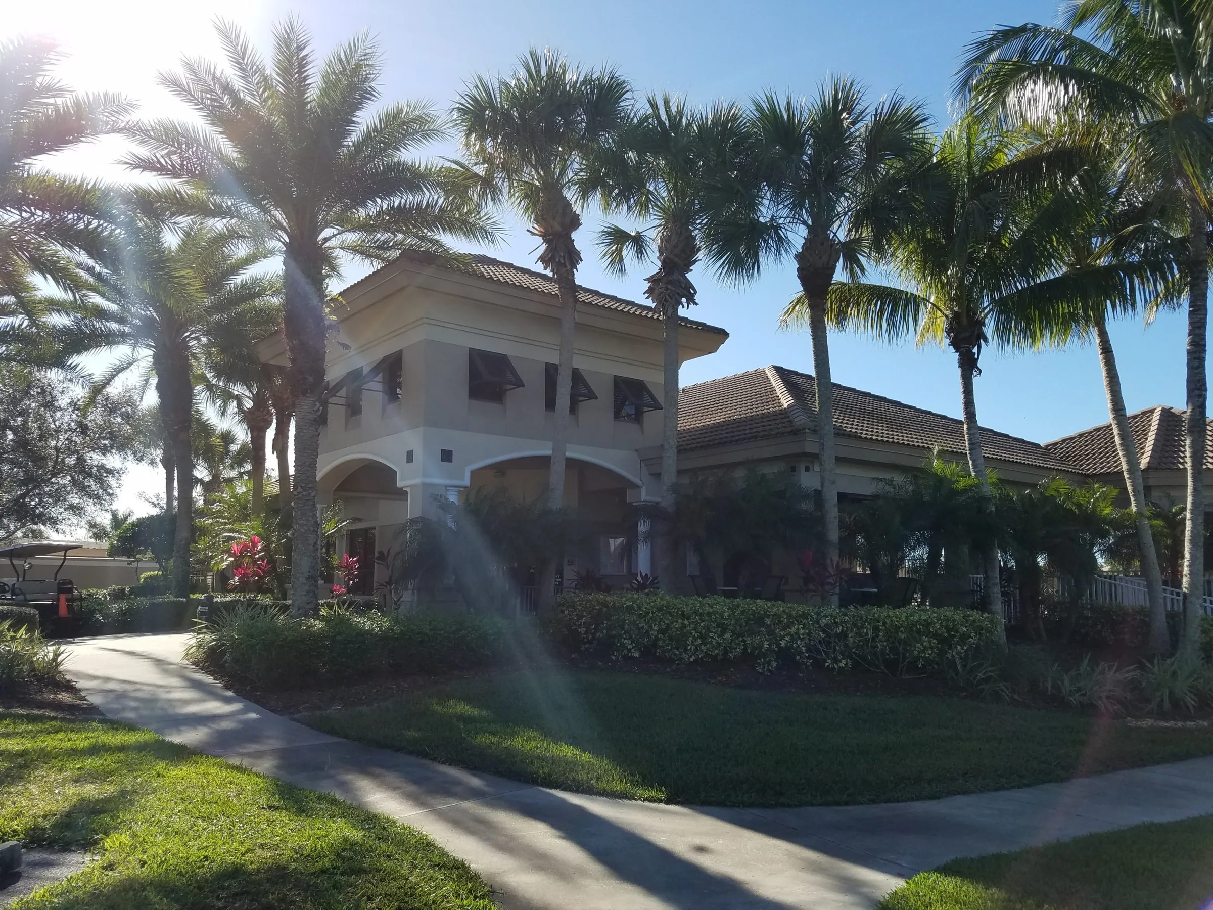 Clubhouse building framed by palms at Crown Colony, Fort Myers (official community and club sites).