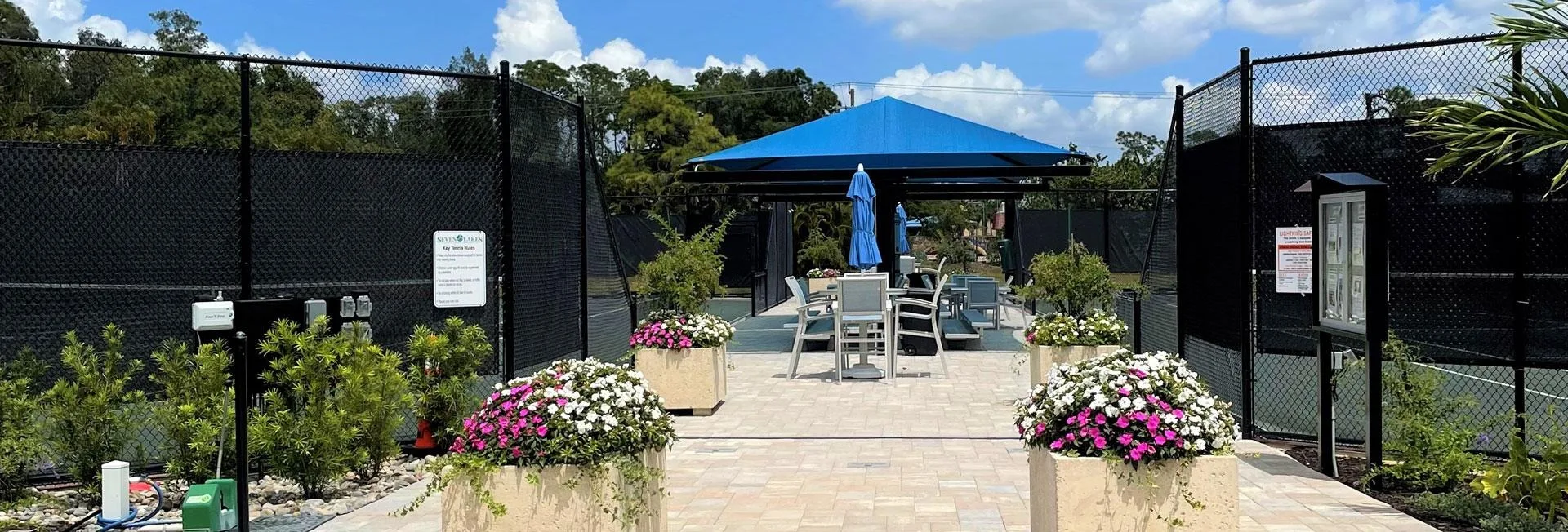 Tennis complex with shaded seating at Seven Lakes, Fort Myers (official association site).
