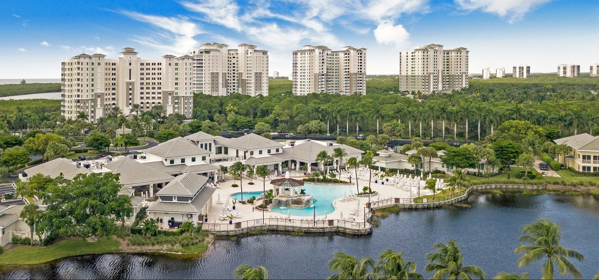 Aerial view of The Club, lake and residential towers at The Dunes of Naples.