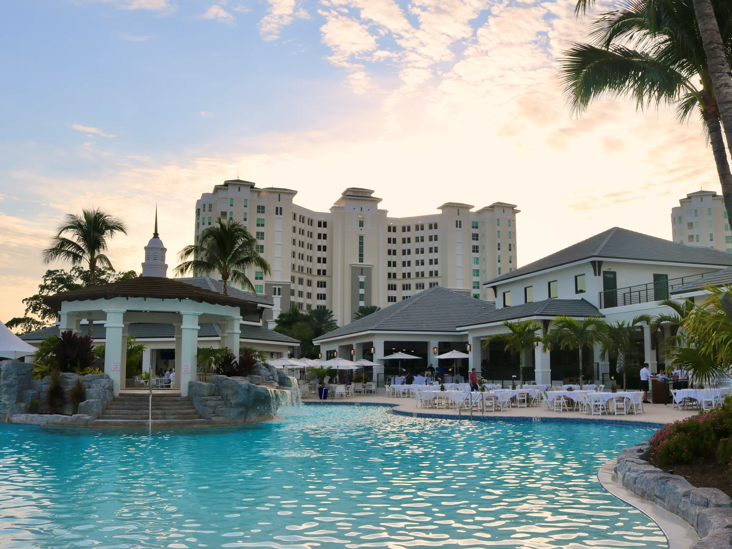 Resort pool at sunset at The Club at The Dunes of Naples.