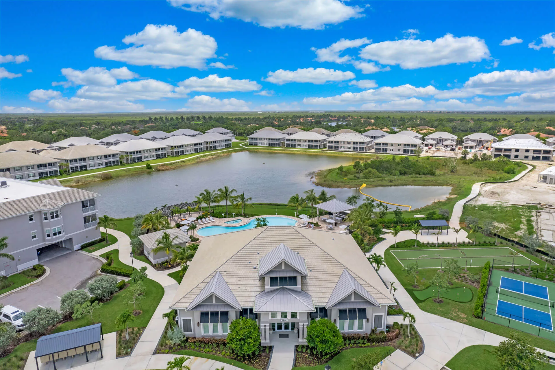 Aerial view of the Antilles clubhouse, pool, and courts in Naples (official developer site).