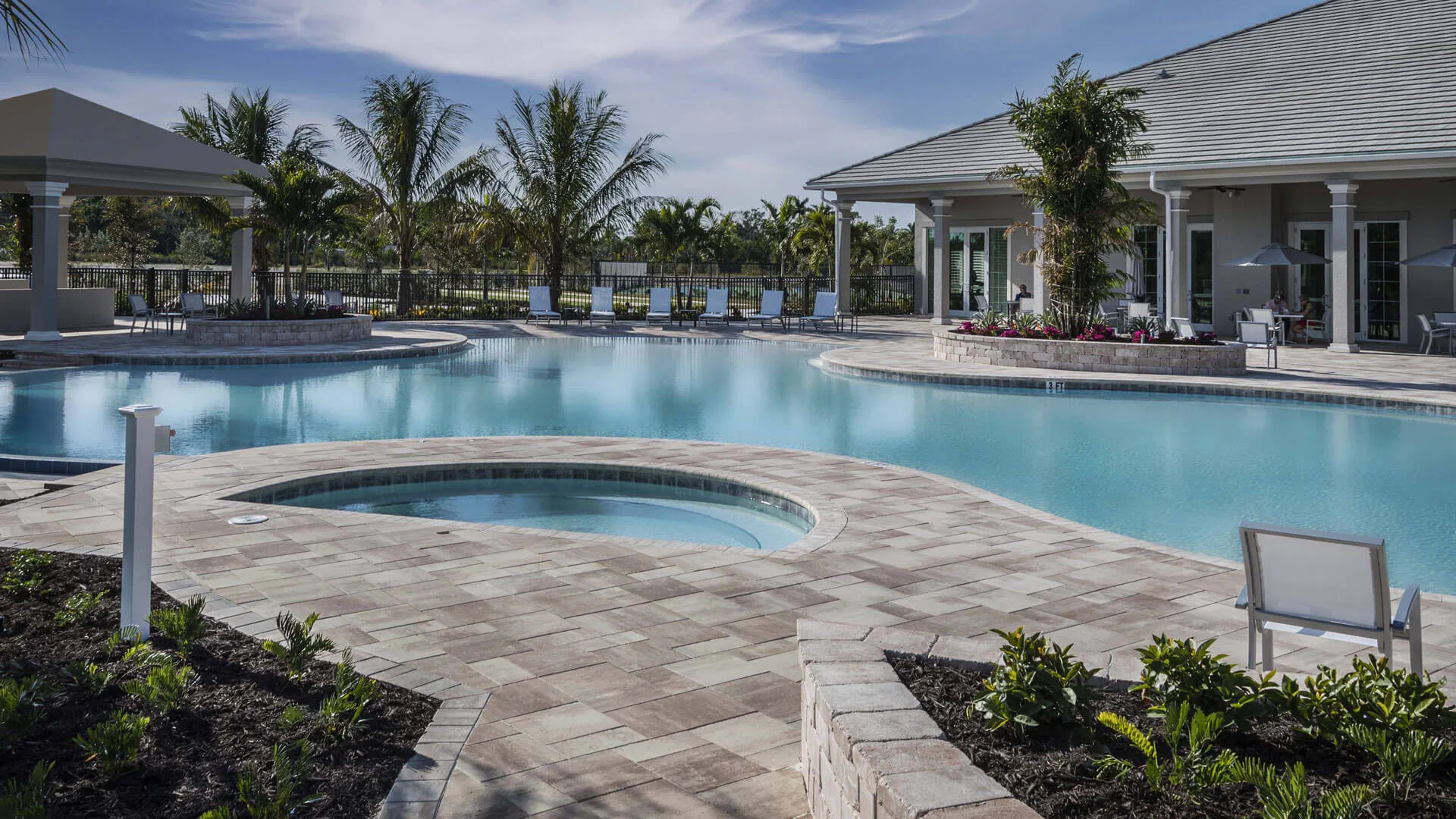 Resort pool and clubhouse at dusk, Antilles Naples (official developer site).